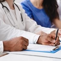 Image of people writing at a table