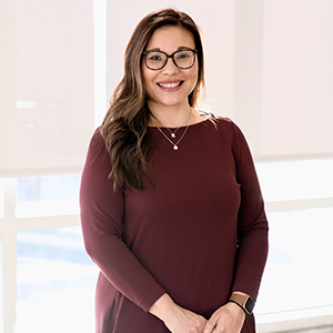  Headshot of Lynn Hernandez wearing a maroon dress