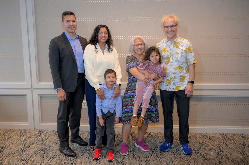 Ambros and Lee stand with their son, daughter-in-law and grandchildren at the UMass Club in Boston on the day of the Nobel announcement.&nbsp;