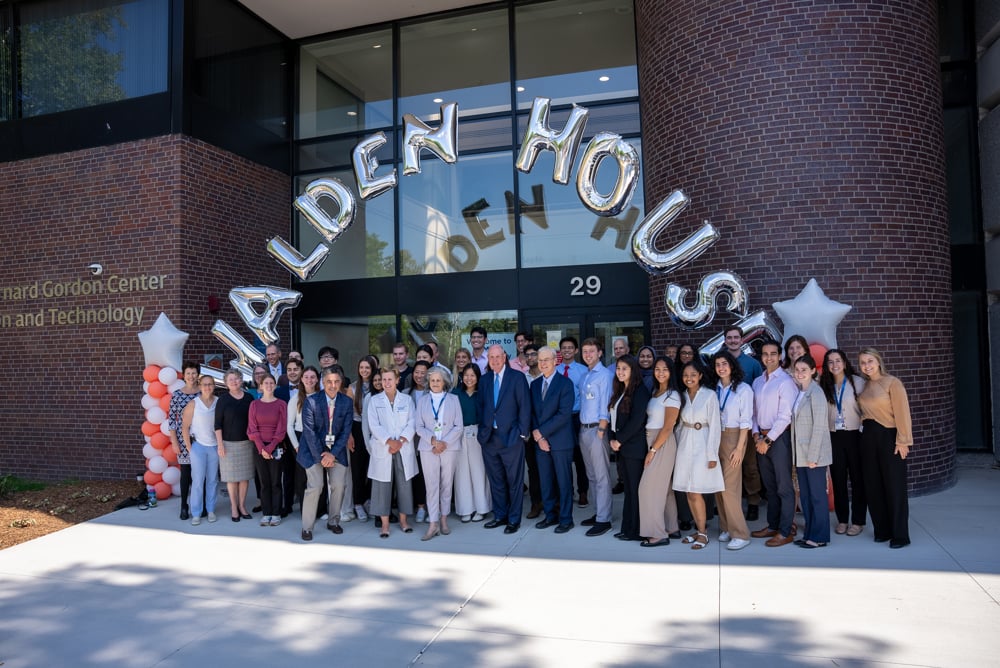 The inaugural cohort of LEAD@Lahey medical students&mdash;32 strong&mdash;gather on the UMass Chan-Lahey regional campus in Burlington. They are gathered in front of a building below a balloon arch thats spells out Walden House. 
