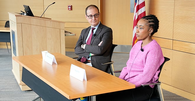 Presenters at a table facing the group of media fellows