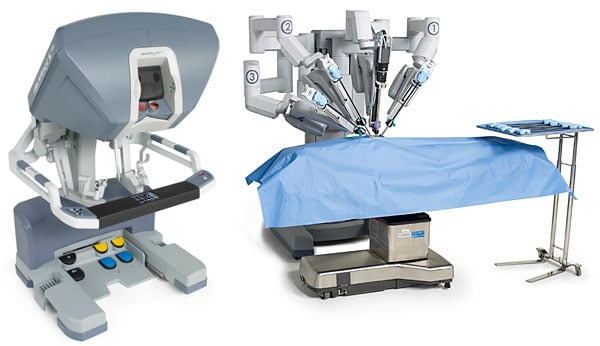 Image of two surgery robots and an exam table