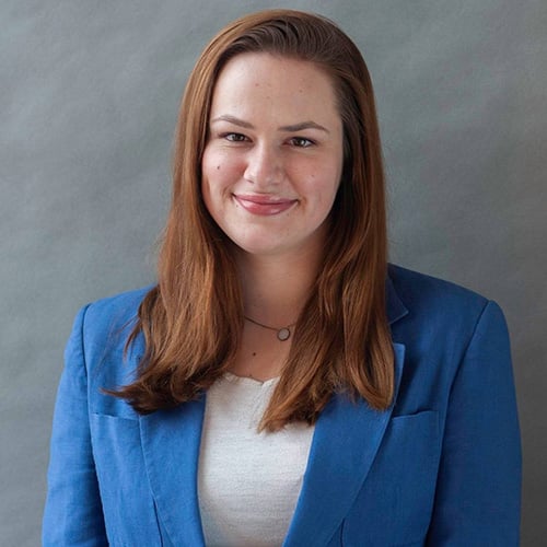 White woman with shoulder length reddish hair