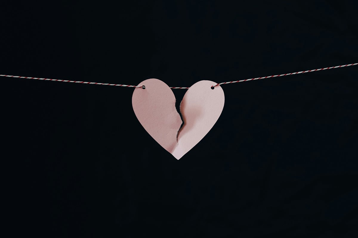 broken paper heart hanging on a string