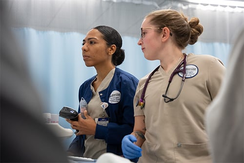 Photo of two nurses wearing scrubs