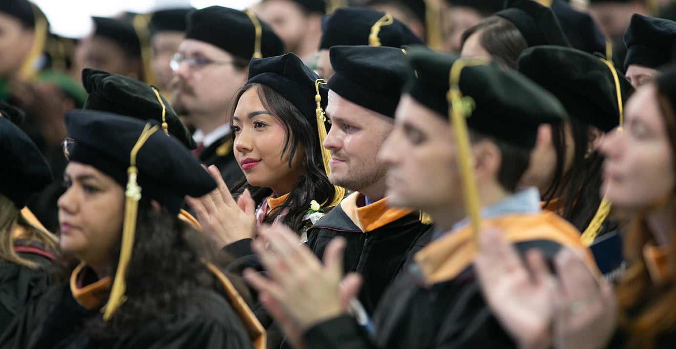 Photo of Anita Tran, DNP, and Joseph Tulip, DNP, with other graduates of the Tan Chingfen Graduate School of Nursing